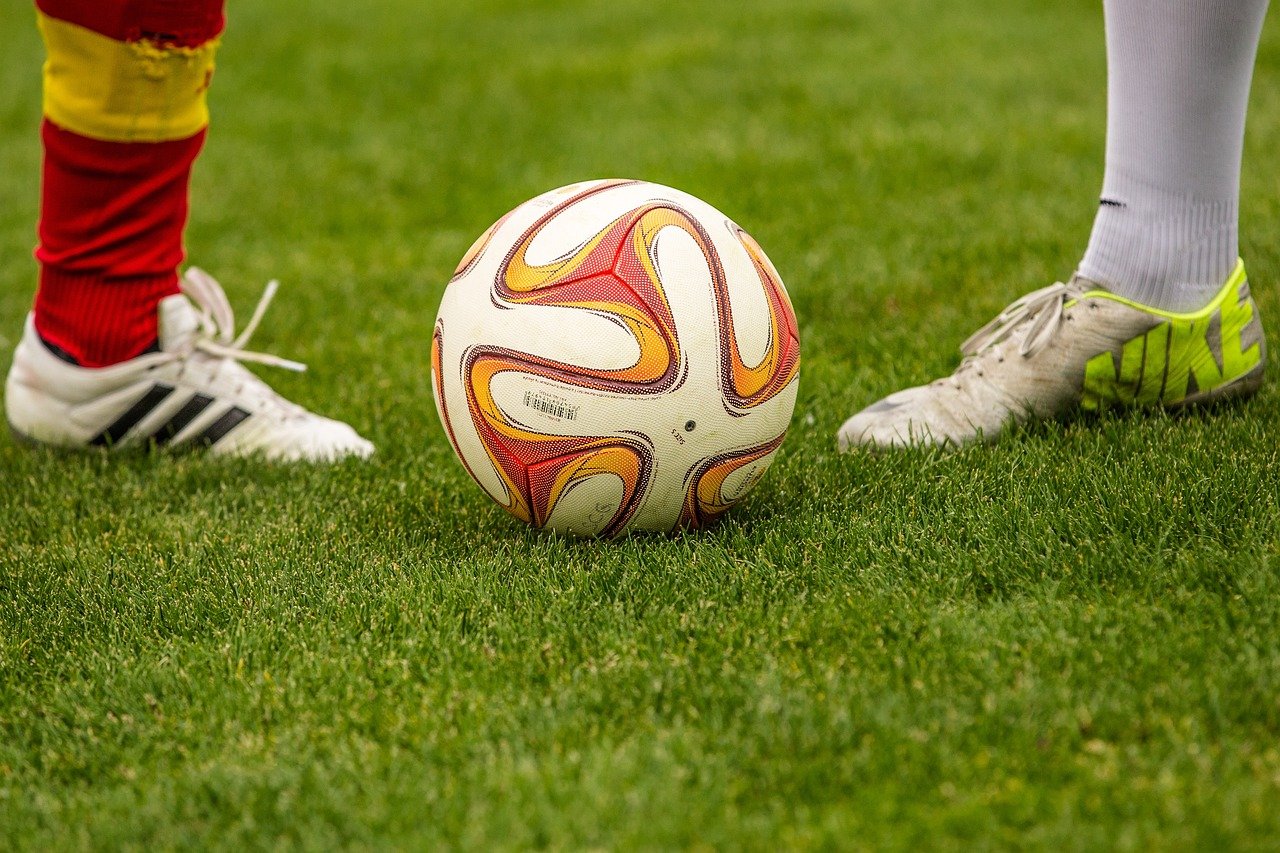 two players waiting to hit the football in a competition