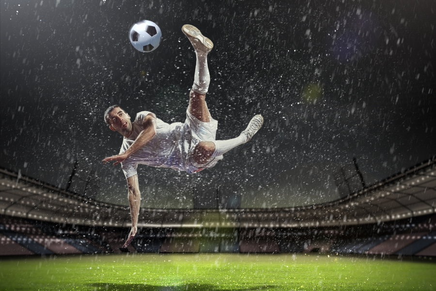 a person hitting a soccer ball