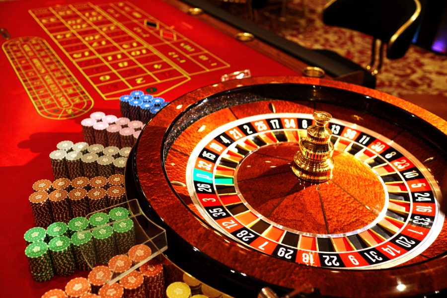 a roulette wheel with poker chips around it
