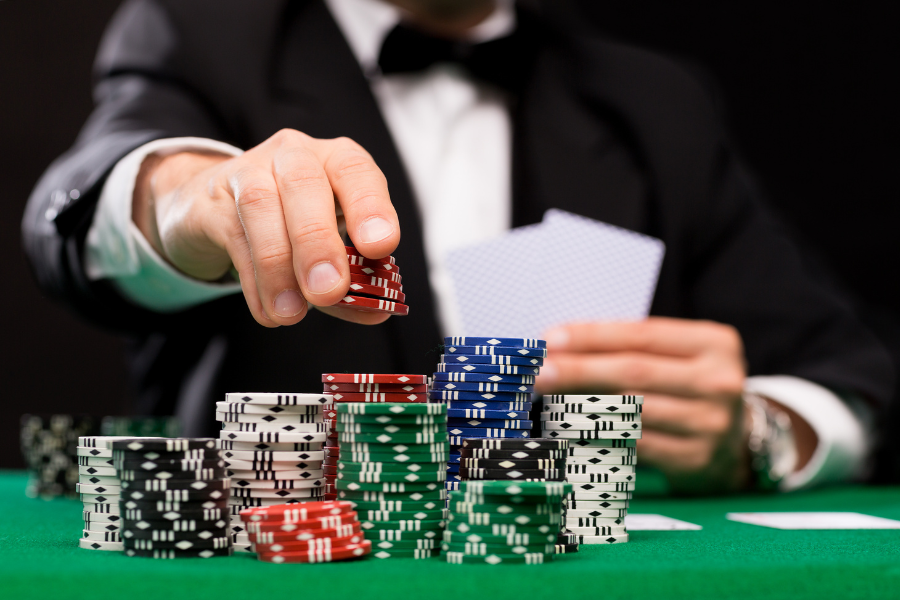 A person playing poker, holding poker chips