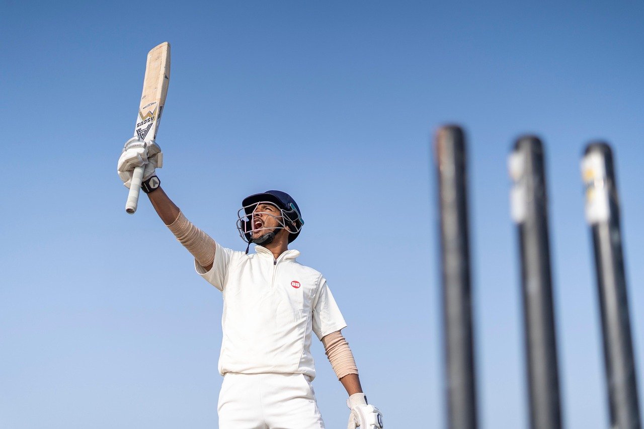 a cricket player posing victory
