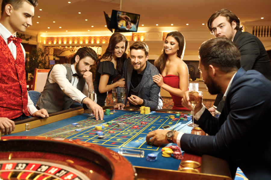 a group of people playing casino games in a casino